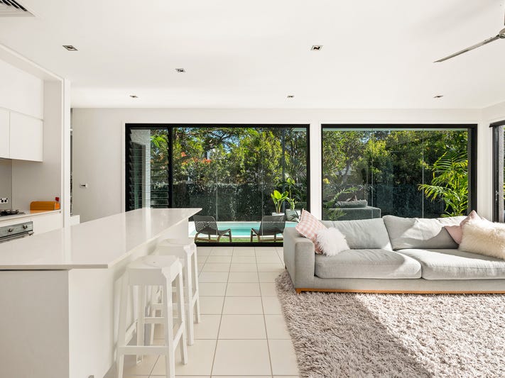 Light-filled modern home surrounded by pools, parks, gardens, and cafes
